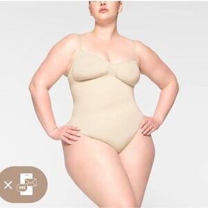 SKIMS Seamless Thong Sculpt Bodysuit SHAPEWEAR in a light nude color